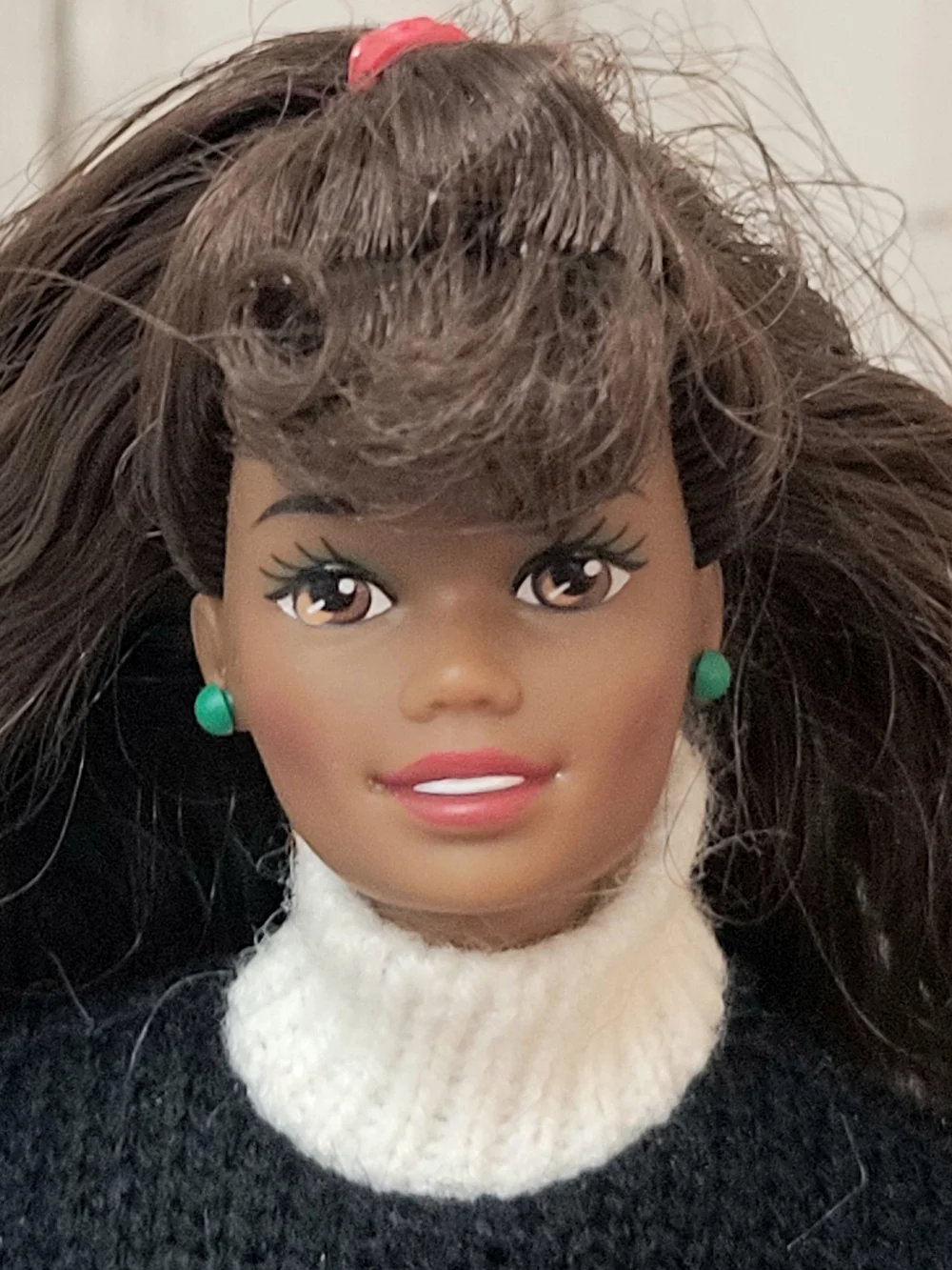 Brunette Doll with Green Stud Earrings and White Turtleneck